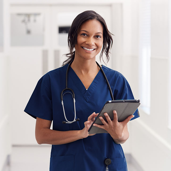 Medical technician poses with a tablet